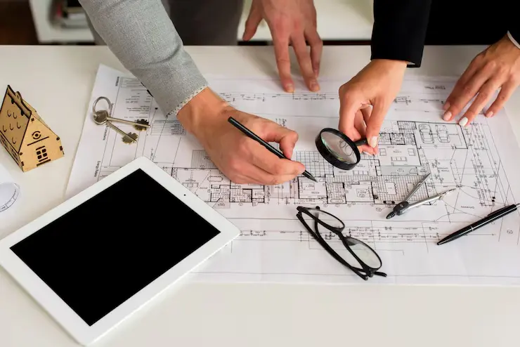 How Do I Start Architectural Drafting? 2 architects analysing plan with magnifier 23 2148252113