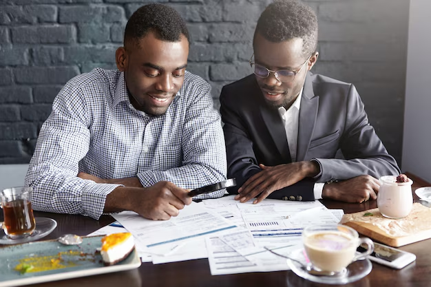 Simple Ways to Improve Your Budgeting Skills Today 2 An organized desk with a budgeting notebook, calculator, and coffee mug, highlighting financial planning with tips from a financial consultant.