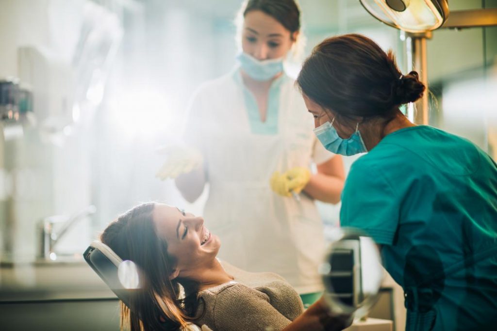 How Can a Dental Health Care Group Support Dental Assisting Programs? 1 dentists with smiling patient in chair 1024x683 1